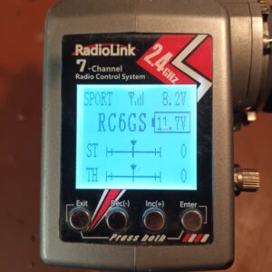 Close up of the screen on a Radiolink RC6GS V3 turned on showeing voltage of the car and the transmitter